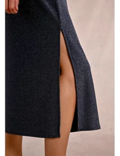 Chaqueta larga en tejido brillante con flecos