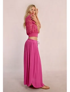 Falda larga plisada con lazada